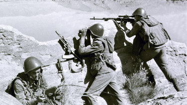 Soviet soldiers observe the highlands, while fighting guerrillas at an undisclosed location in Afghanistan.