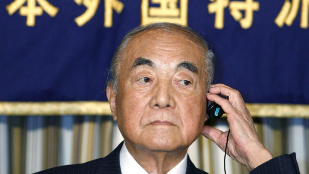 Japanese Prime Minister Yasuhiro Nakasone adjusts earphone during a press conference in Tokyo in 2007.