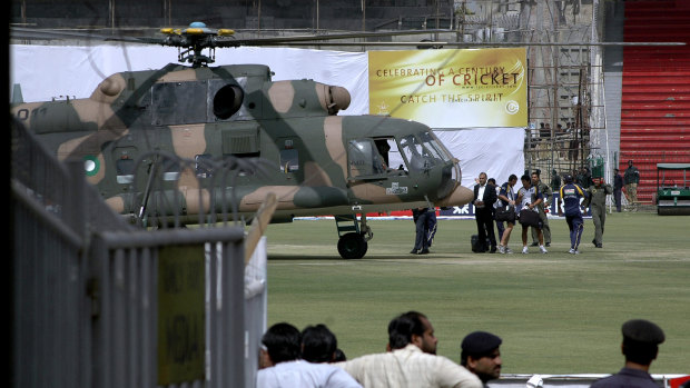 Sri Lankan officials and players prepare to board a helicopter at Gaddafi Stadium after the shooting incident in Lahore in 2009.