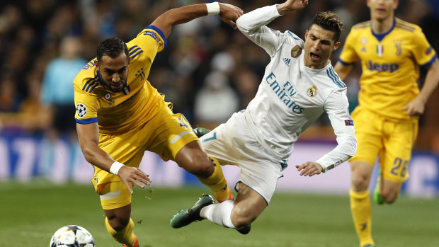 He\'ll soon wear yellow too: Real Madrid\'s Cristiano Ronaldo as he was tackled by Juventus\' Medhi Benatia during a Champions League match in April. 