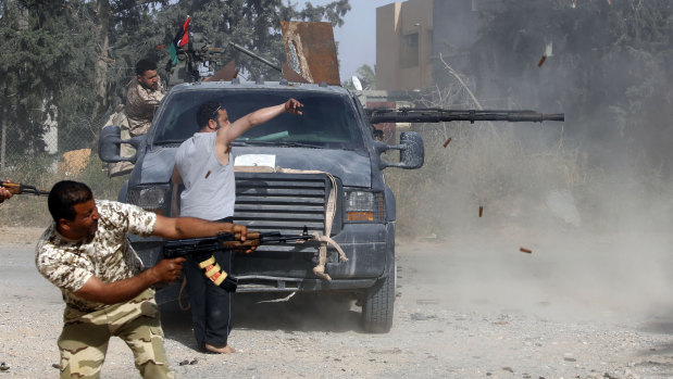 Libyan fighters loyal to the Government of National Accord (GNA)  fire their guns during clashes with forces loyal to strongman Khalifa Haftar south of Tripoli.