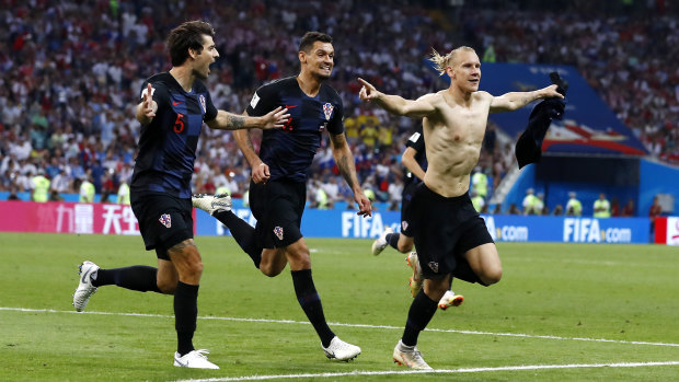 Look at my abs:  Croatia's Domagoj Vida earned himself a yellow card for removing his shirt.