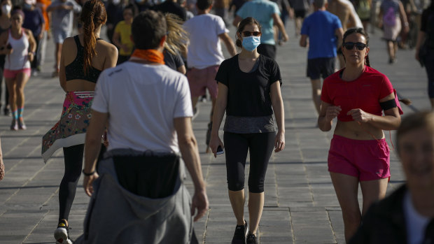 Runners on a seafront promenade in Barcelona on the first weekend the lockdown was eased for exercise.