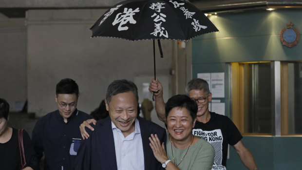 Occupy Central leader Benny Tai, front left, is accompanied by pro-democracy lawmaker Helena Wong, family members and supporters as he leaves the High Court on Thursday.