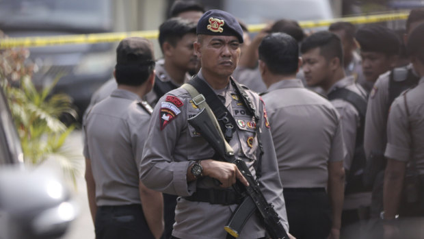 A police officer stands guard near the site of a bombing attack in Sumatra, Indonesia, last month.