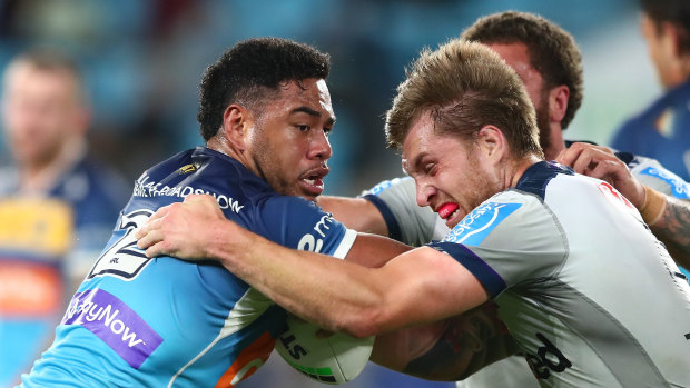 Greg Marzhew of the Titans tries to break free from Melbourne’s Cameron Munster.