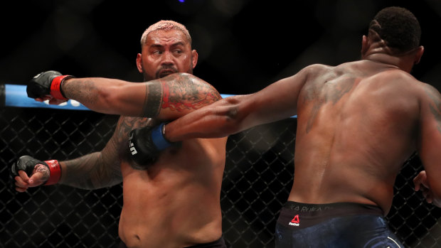 Bowing out: Mark Hunt takes a swing at Curtis Blaydes.