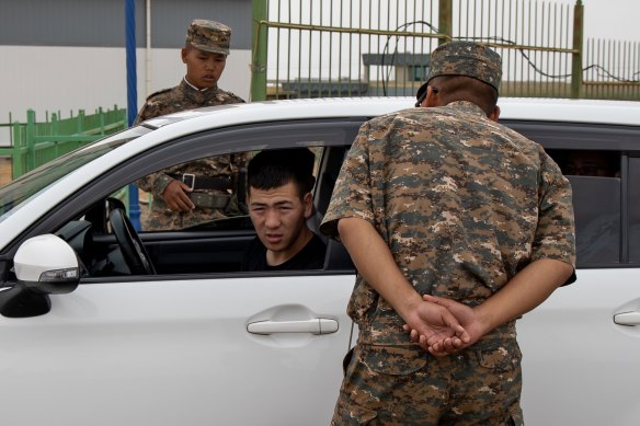 Mongolian military check cars passing through the border with China in Zamiin-Uud.