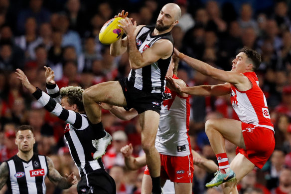 Veteran Magpie Steele Sidebottom flies for a mark.