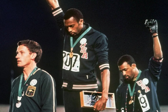 US athletes Tommie Smith and John Carlos, with Australia's Peter Norman, in their famous pose at the 1968 Games in Mexico. 