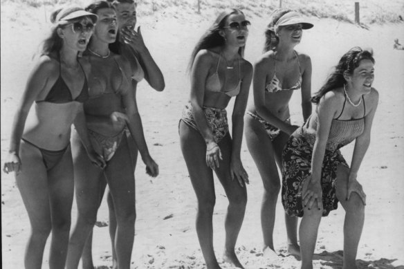 The surfie chicks in the Greenhills Gang watch their guys surf in a scene from Puberty Blues.