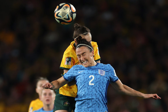 Caitlin Foord of Australia contends for the aerial ball with Lucy Bronze of England.