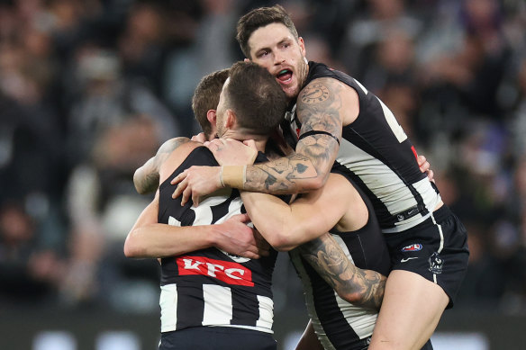 Jack Crisp (R) hugs Magpies Jeremy Howe, Brayden Maynard and Will Hoskin-Elliott on the final siren.