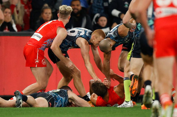 Sam Docherty and Josh Kennedy on the ground after their collision.