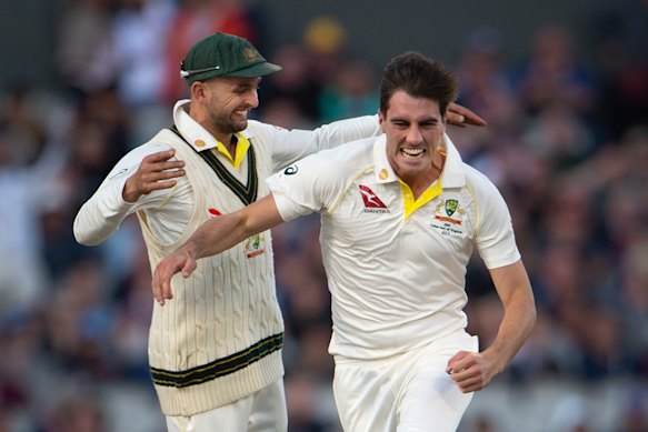 Pat Cummins celebrates with Nathan Lyon after bowling Joe Root at Old Trafford on the last Ashes tour four years ago.