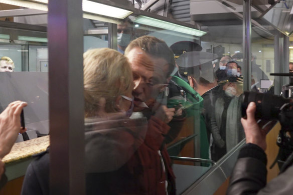 In this photo taken from video, Alexei Navalny kisses his wife Yulia as he is detained by police at the passport control after arriving at Sheremetyevo airport, outside Moscow, Russia.