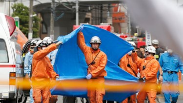 Rescuers work at the scene of an attack in Kawasaki, near Tokyo.