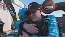 Zach Bates embraces his father, Rick, after securing pole position.