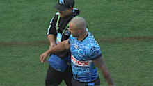 Braydon Trindall leaves the field with a shoulder injury.