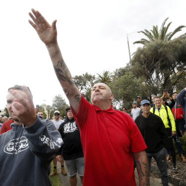 A protester issues a Nazi salute at rally in St Kilda.