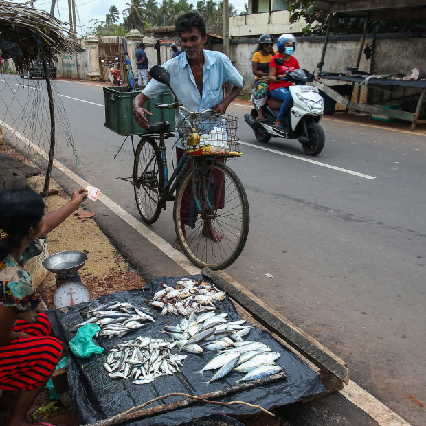 A woman sells fish by the side of the road on Sri Lanka’s central west coast.