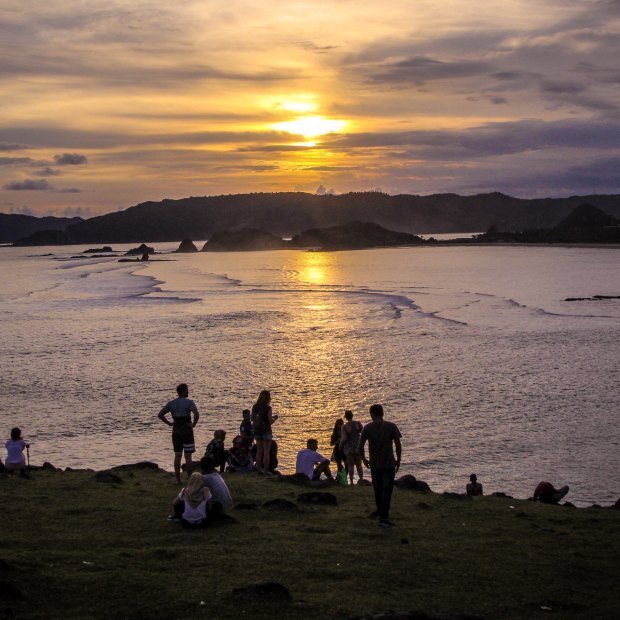 Tourists and locals gathering to watch the sunset on Bukit Merese Hill in Lombok's south.