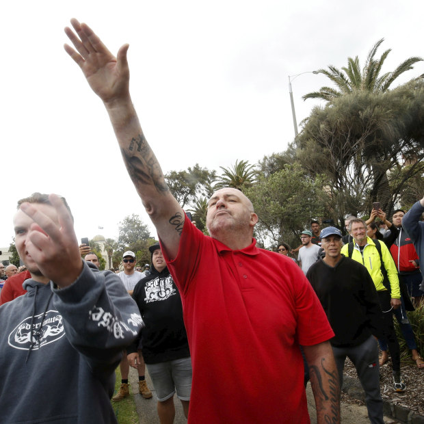 A protester issues a Nazi salute at rally in St Kilda.