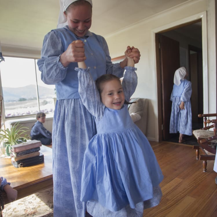 Elizabeth and Abi have fun before chores start; Ruth and Esther look on.