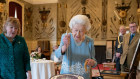 The Queen cuts a cake to celebrate the start of her platinum jubilee, marking 70 years on the throne.