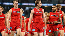 Suns players leave the field after the Carlton loss.