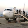 Passengers board Qantas 737 at Launceston Airport after mystery flight