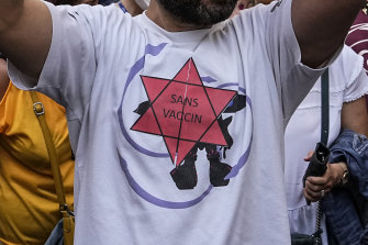 An anti-vaccine protester  in Paris on Saturday wears a star that reads “without vaccine”. 
