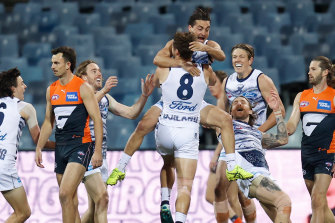 Players celebrate with Jake Kolodjashnij after the defenderâ€™s first career goal.