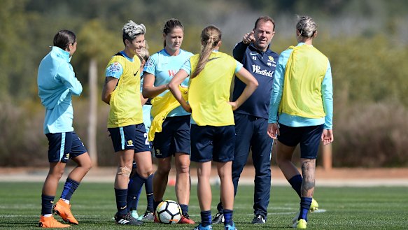 Matildas players listen to direction from Stajcic in 2018.