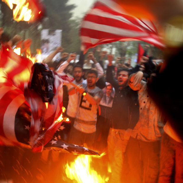 Iranian demonstrators burn representations of the US flag during a protest in front of the former US Embassy after Donald Trump pulled the US out of the nuclear deal.