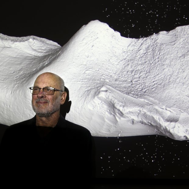 Professor Tim Flannery, honorary associate of the Australian Museum, with the fossil of a newly described monotreme.