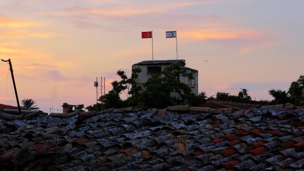 A Turkish military guard post with Turkish, left, and Turkish Cypriot breakaway flags on the polls is seen at the Turkish Cypriot controlled area at the north part of the divided capital Nicosia, Cyprus,