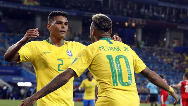 Brazil's Thiago Silva celebrates with teammate Neymar after scoring against Serbia.