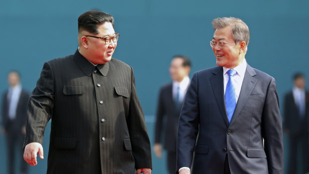 North Korean leader Kim Jong-un, left, talks with South Korean President Moon Jae-in, right, after the welcoming ceremony at the border village of Panmunjom.