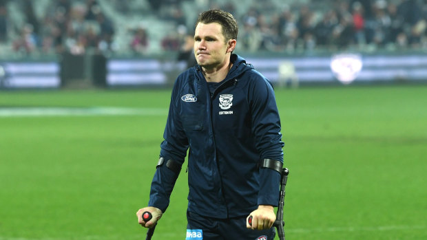 Patrick Dangerfield walks off the field on crutches.