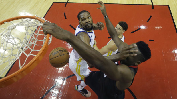 Houston's Clint Capela scores despite some close attention from Kevin Durant.