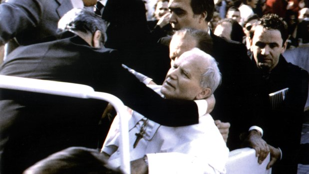 Pope John Paul lies wounded in St. Peter's Square after the assassination attempt.