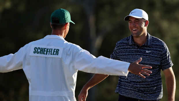 Scottie Scheffler celebrates his Masters win with caddie Ted Scott.