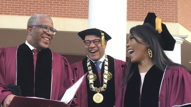 Robert F. Smith, left, laughs with David Thomas, centre, and actress Angela Bassett at Morehouse College.