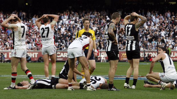 As the final siren sounds, shattered Saints and Magpies players throw up their arms in stunned confusion.