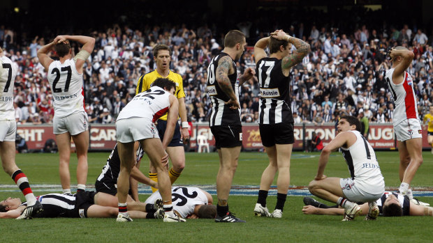 As the final siren sounds, shattered Saints and Magpies players throw up their arms in stunned confusion.