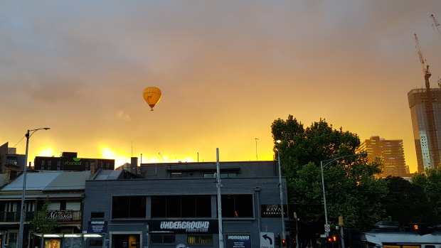 A hot-air balloon in the cloudy sky.
