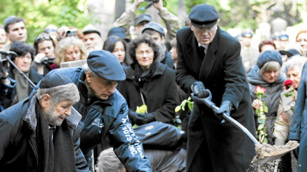 Paula Sawicka (centre, holding daffodils) watches as Marek Edelman is laid to rest. 