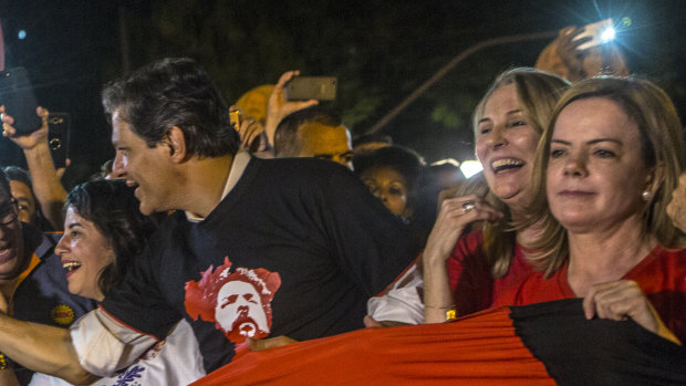 Fernando Haddad, former mayor of Sao Paulo, third right, and Senator Gleisi Hoffman, president of the Workers' Party (PT), right, join demonstrators during a rally against local government officials and in support of Lula.