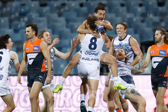 Players celebrate with Jake Kolodjashnij after the defender’s first career goal.